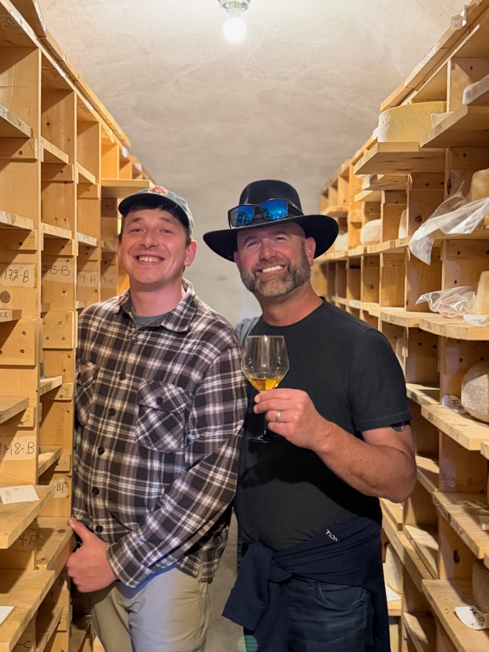 Friends with a glass in the cheese cave