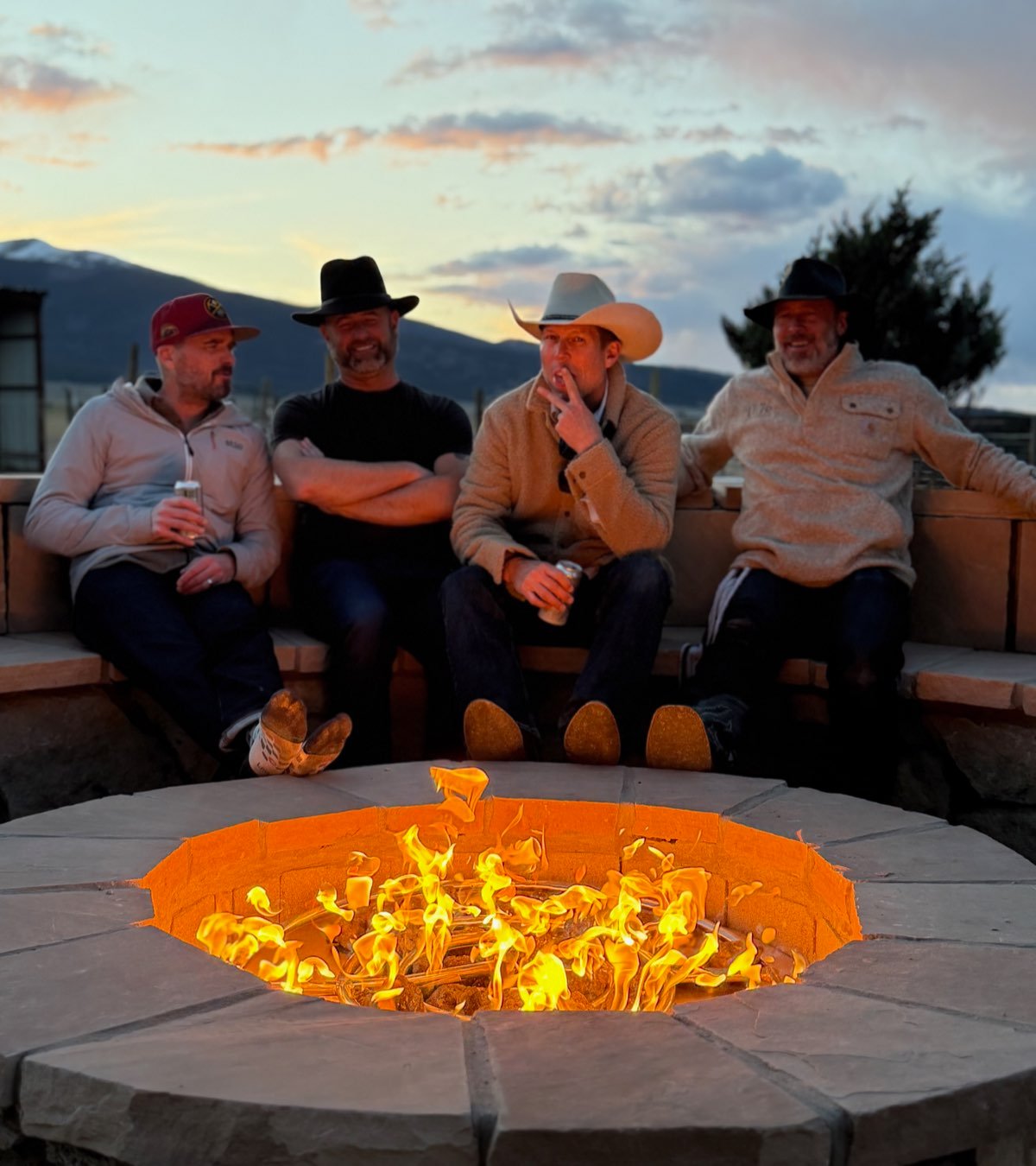 Gathering around the stone fire pit at sunset